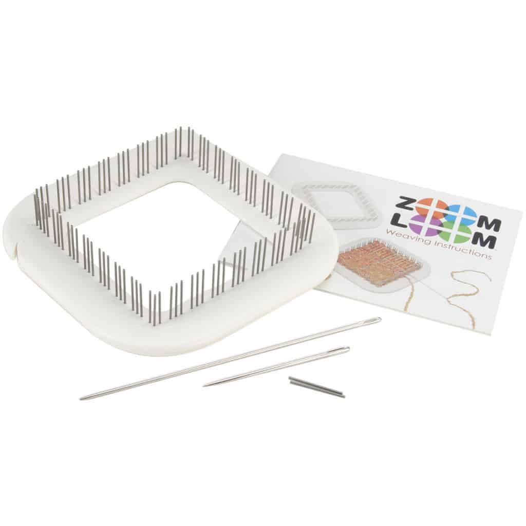 “Small white Zoom Loom pin loom with needles, pins, and instruction booklet.”