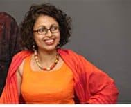 Nadishka Aloysius dark hair, glasses, orange dress --review of Roo the little red tuk tuk