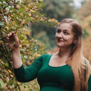 Blood Awakens - Jessaca Willis - long blond hair green top , posed by a tree