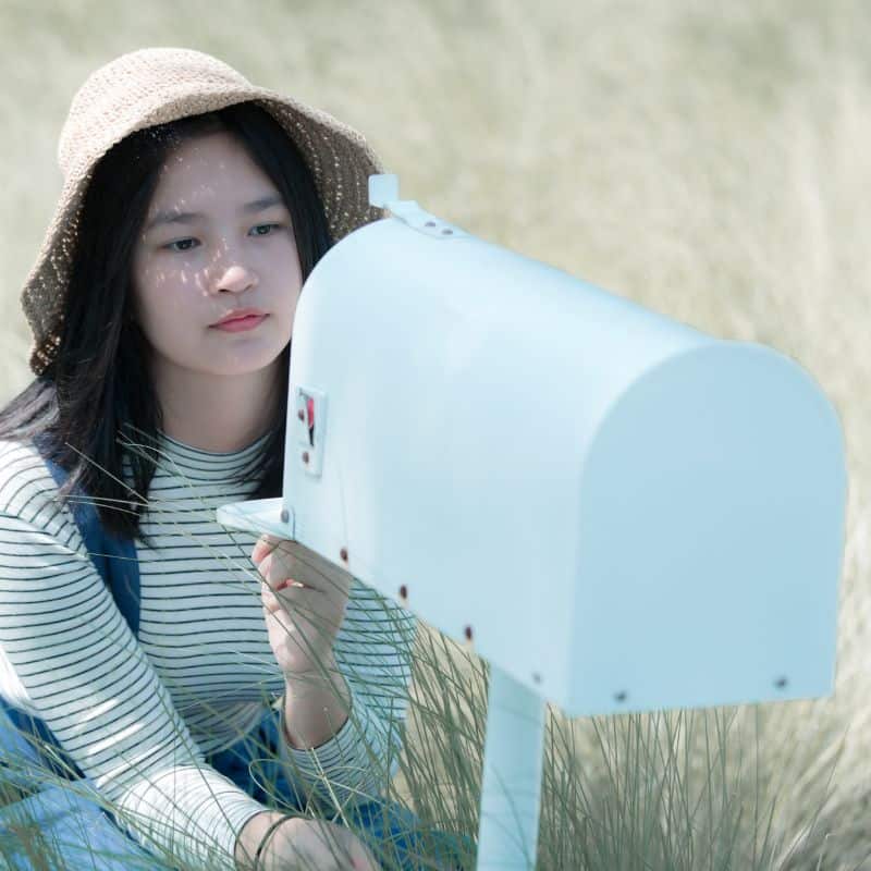 Girl waiting for letter at open mailbox insta Handwritten Letter article