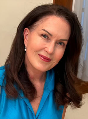 Author Wendy Murphy wearing a blue blouse and smiling with a neutral background