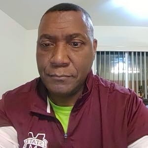 Harold Phifer In a dark red shirt, military haircut, stern face