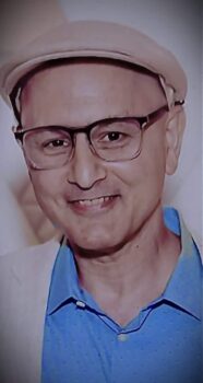 Michael De Stefano author profile headshot wearing blue shirt & glasses