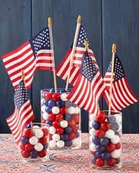 red white & blue candy in clear jars with mini flags decorations