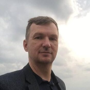 Book Review: The Book of Kindness by Egor Klopenko | Gentle Children’s Tales of Empathy & Compassion 5 Headshot of Egor Klopenko, author of 'The Book of Kindness'. He is wearing a dark blazer, with a cloudy sky background.