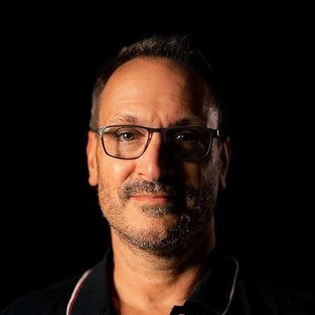 “Author Phil Marshall headshot — glasses, slight smile, dark background
