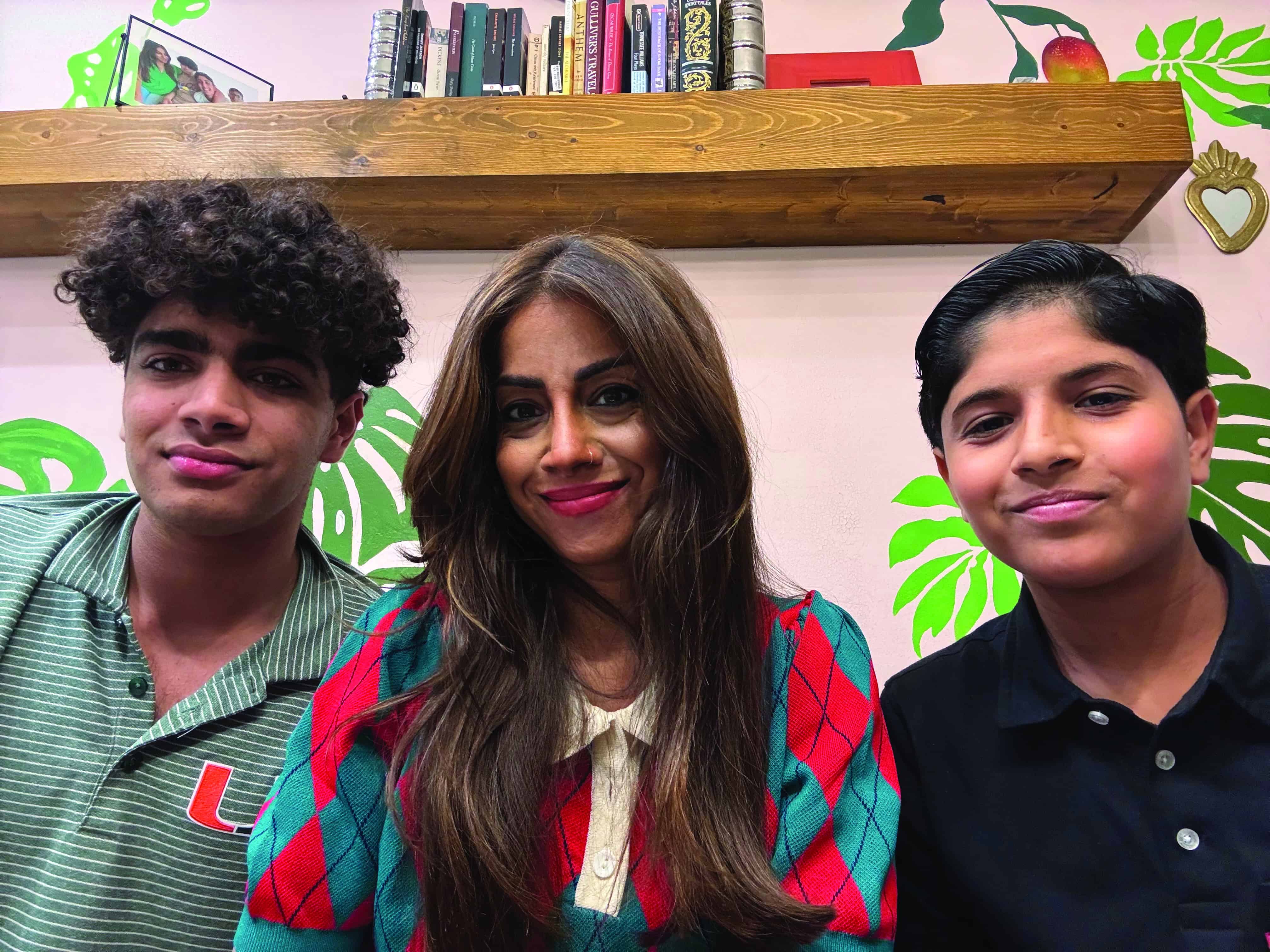 Review: The Boy Who Cried Wolf (and Other Great Stories with Lessons) by Dr. Uzma Farooq 5 “Photo of Dr. Uzma Farooq with her two sons and co-authors, Samir Ahmad and Amani Ahmad, smiling together in front of a bookshelf and leafy wall mural.”