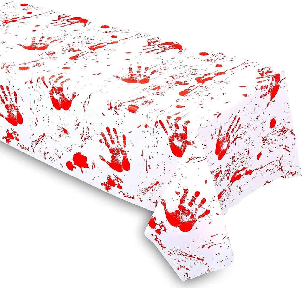 Halloween party tablecloth printed with realistic red handprints and blood splatters on a white background, creating a creepy and dramatic effect for horror-themed décor.