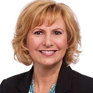 Professional headshot of author Elizabeth Pantley, smiling and wearing a dark blazer and turquoise jewelry, with a plain white background.