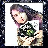 Kayleigh Kavanagh author image with purple + brown hair holding a collection of her books