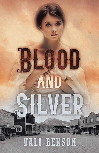 A young girl featured in sepia above a black and white frontier town on the bookcover for Blood and Silver by Vali Benson