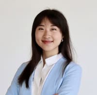 Unforgettable & Gripping: The Thieves Carousel by Briana Chen | Review + Guest Post 5 "Author photo of Briana Chen wearing a white blouse and light blue blazer, smiling with arms crossed in front of a white background."