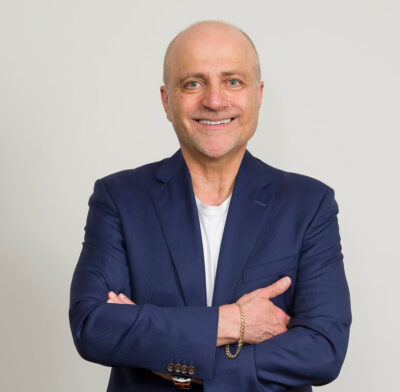 The Guerrilla Guide for Entrepreneurs & the Rest of Us by Joseph Gulesserian | Book Review 9 Joseph Gulesserian author image - with folded arms, navy blue suit, facing camera with a smile