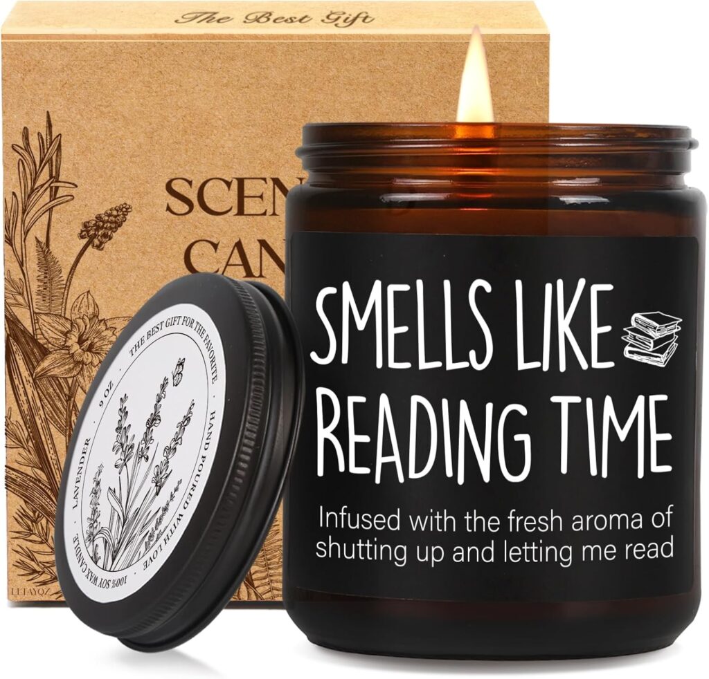 Amber glass candle labeled "Smells Like Reading Time" with a humorous subtext about being left alone to read, shown lit beside its lid and gift box.