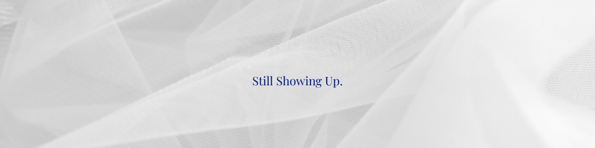 Eight Years of Reading, Writing, and Finding My Voice 2 Horizontal closing divider image displaying the text "Still Showing Up" centered on a soft neutral textured background, matching the mid-post divider used in the blog’s eight-year anniversary post.
