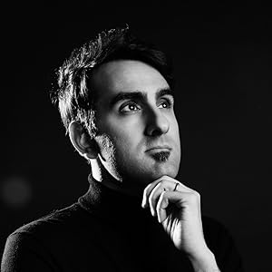 Black-and-white author portrait of Soheil Mirchi looking upward thoughtfully with hand resting under chin against a dark background.