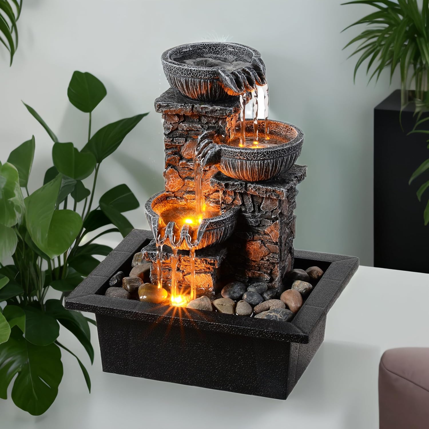 Three-tier tabletop fountain with flowing water and warm LED lighting designed to create soothing ambient sound and a calm atmosphere.
