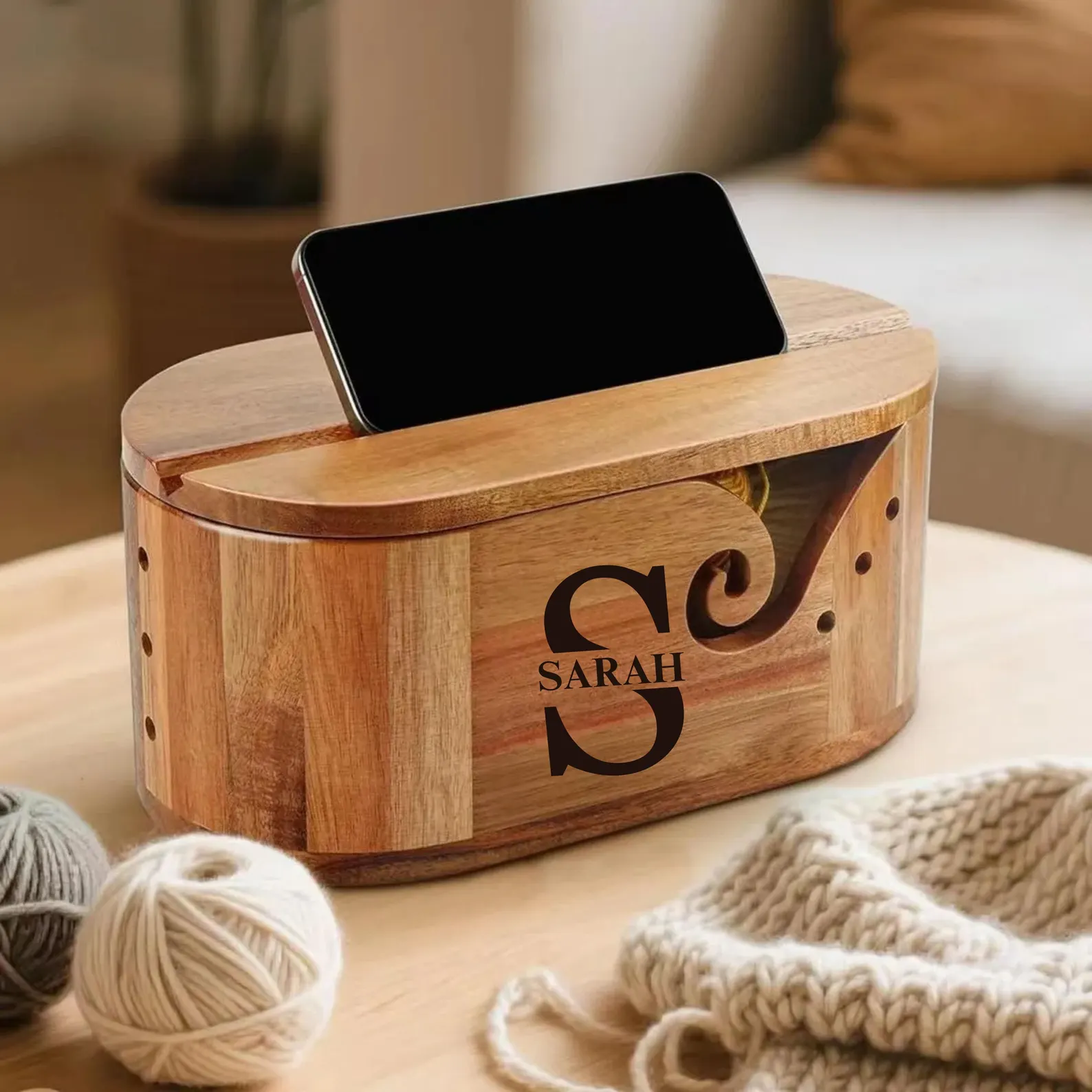 Handcrafted yarn bowl with built-in phone holder designed to keep yarn tidy while knitting or crocheting.