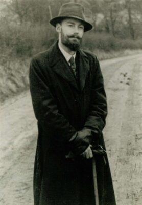 Historical black-and-white portrait photograph of author Peter Stark Lansley wearing a coat and hat outdoors.