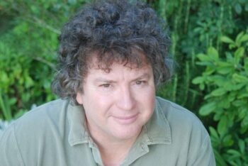 Review: The Trafficker by Scott Douglas Gerber 2 Author photo of Scott Douglas Gerber outdoors against a green natural background, used in connection with the novel The Trafficker on GinaRaeMitchell.com.