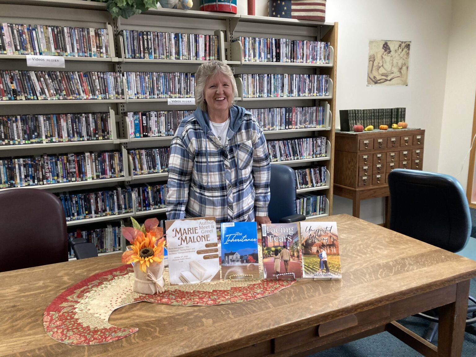 Author Marie Malone featuring three of her books at a Chrisman Public Library Meet & Greet