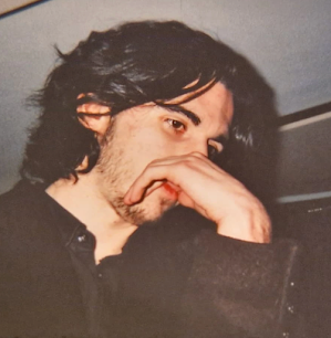 Feature: Fablenoir by Vic Sinclair | Dark Urban Fantasy 3 Author Vic Sinclair portrait with dark hair, resting his hand near his face in a candid, contemplative pose.