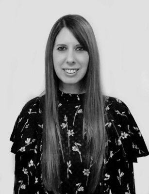 Black-and-white author photo of Patricia Leavy smiling with long straight hair and a floral-patterned blouse against a light background.
