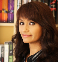 A Dagger in the Ivy by Dorothy Dreyer | Award-Winning Fae Romantasy | Blade Bound Saga Book 1 3 author Dorothy Dreyer in a semi-side view with bookshelves in the background
