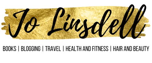 Blog header for JoLinsdell.com features Jo Linsdell in black cursive on a gold color swash with a subtitle of Books,blogging, travel, health and fitness, hair and beauty