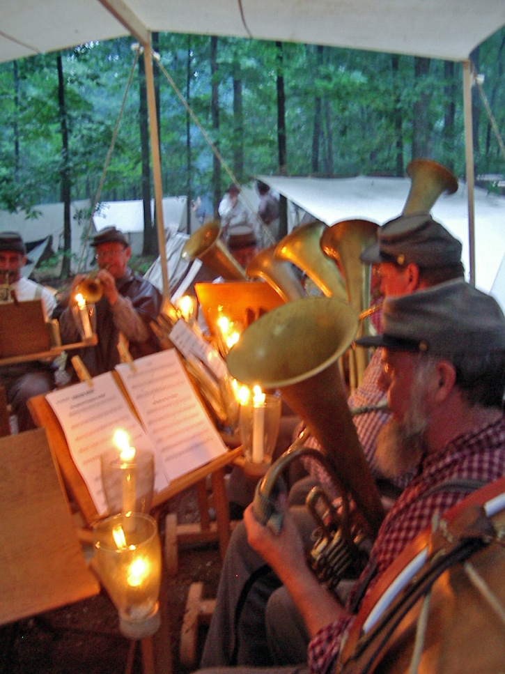 An informal evening concert at a Civil War reenactment camp, illustrating the historical experiences that inspired M.F. Jones.