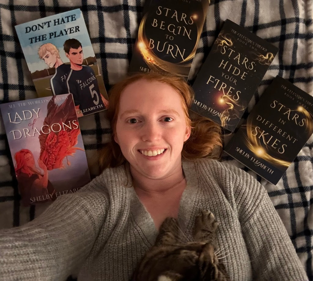 Lady of Dragons Part One by Shelby Elizabeth | BBNYA 2025 Semi-Finalist Spotlight 6 “Portrait of author Shelby Elizabeth, smiling warmly. Used in BBNYA 2025 spotlight on ginaraemitchell.com.”